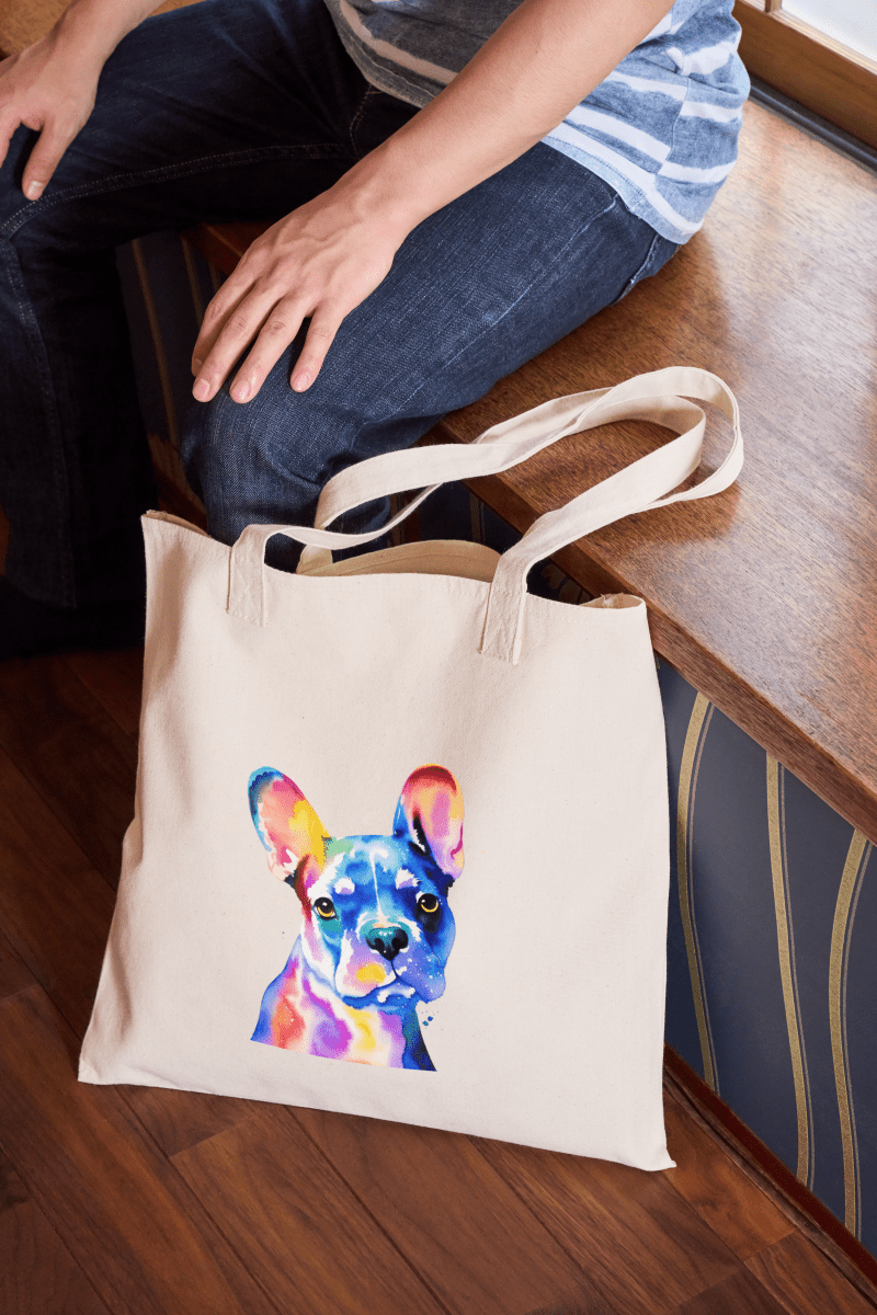 Image of the watercolour pet portrait tote bag sat by a chair
